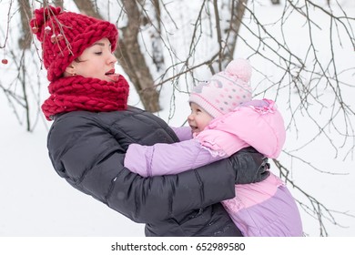 Beautiful Mom And Nice Baby Outdor In A Winter Day