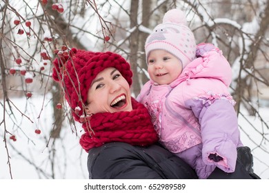 Beautiful Mom And Nice Baby Outdor In A Winter Day