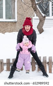 Beautiful Mom And Nice Baby Outdor In A Winter Day