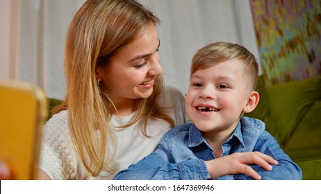 Beautiful Mom And Son Making Selfie At Home. Happy Family Having A Facetime Video Call. Unity, Connection, Technology Concept       