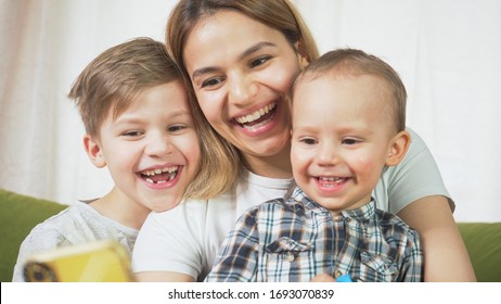 Beautiful Mom With Sons Having A Facetime Video Call. Happy Family Taking Selfies And Video Chatting At Home. Mother's Day, Unity, Connection Concept. 