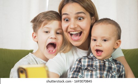 Beautiful Mom With Sons Having A Facetime Video Call. Happy Family Taking Selfies And Video Chatting At Home. Mother's Day, Unity, Connection Concept. 