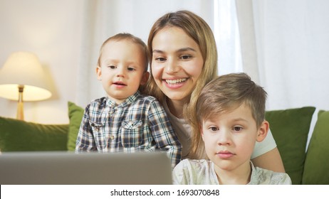 Beautiful Mom With Sons Having A Facetime Video Call. Happy Family Taking Selfies And Video Chatting At Home. Mother's Day, Unity, Connection Concept. 