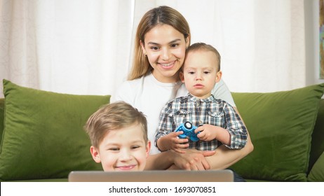 Beautiful Mom With Sons Having A Facetime Video Call. Happy Family Taking Selfies And Video Chatting At Home. Mother's Day, Unity, Connection Concept. 