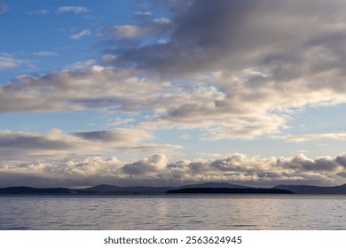 Beautiful morning view of the ocean with scattered clouds over distant islands on the horizon. A serene scene depicting the beauty of nature and tranquility of coastal landscapes. - Powered by Shutterstock