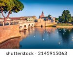 Beautiful morning view of Tiberio bridge and Marecchia river. Attractive summer cityscape of Rimini town, Italy, Europe. Traveling concept background.