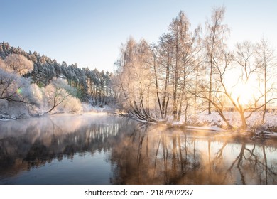 Beautiful morning in winter in the wood. The river without ice in the first month  of winter. Bright rays break through small mist and branches of trees.  - Shutterstock ID 2187902237