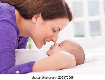 Beautiful mother and baby are gently touching noses - Powered by Shutterstock