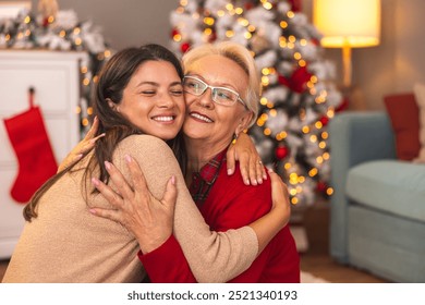 Beautiful mother and daughter enjoying spending Christmas day together at home, mother kissing and hugging daughter - Powered by Shutterstock