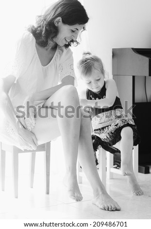 Similar – child girl playing checkers with her dad