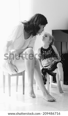 Similar – child girl playing checkers with her dad