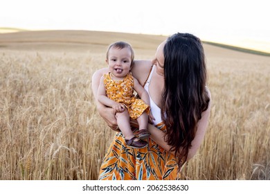 A beautiful mother and daughter in a wheat field. In the country. Laugher and fun.  - Shutterstock ID 2062538630