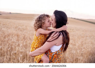A beautiful mother and daughter in a wheat field. In the country. Laugher and fun.  - Shutterstock ID 2064626306