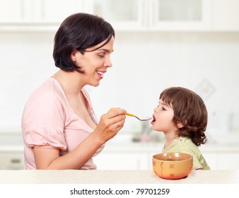 Beautiful Mother Feeding Her Cute Little Toddler Child