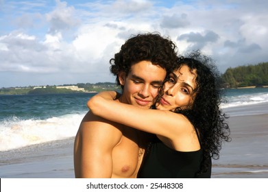 Beautiful Mother Giving Her Teenage Son A Big Hug At The Beach