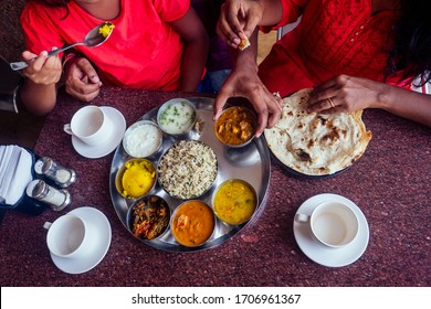 beautiful mother and happy father eating thali with daughter in cafe and drinking masala tea - Powered by Shutterstock