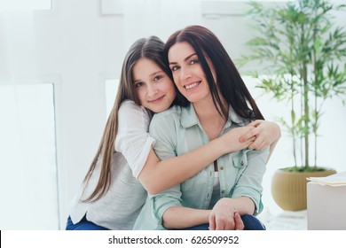 Beautiful Mother And Her Pretty Daughter Teenager Smiling And Posing At Home