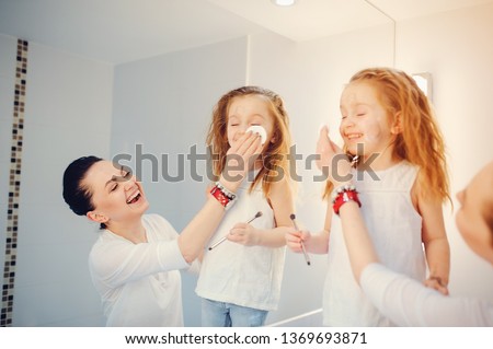 Beautiful mother with little daughter. Family in a bathroom