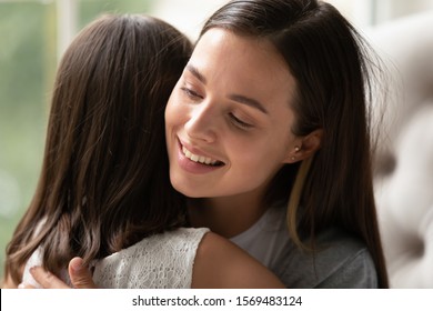 Beautiful Mothers Face Close Up, Mom Strong Cuddling Little Daughter Enjoy Moment Of Tenderness Feeling Unconditional Love To Child Girl. Concept Of Adoption And Sole Custody, Protection Of Offspring