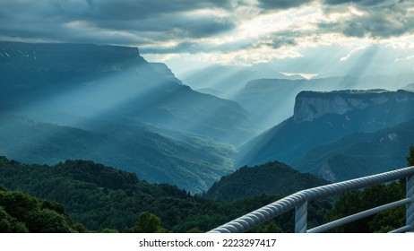 A Beautiful Mountain Gorge With Clouds And Sunset Rays Streaming Through The Clouds. Beautiful Summer Mountain Scenery. Photo Wallpaper