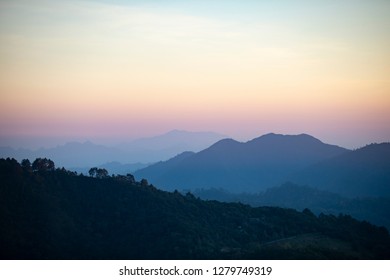 Beautiful mountain landscape before sunrise with morning foggy on the mountain. Layers of mountain background. - Shutterstock ID 1279749319