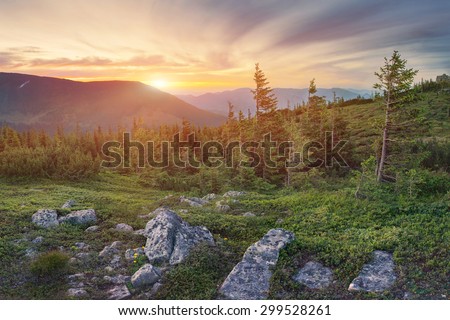 Beautiful mountain landscape with dramatic sky on sunset in Carpathian mountains