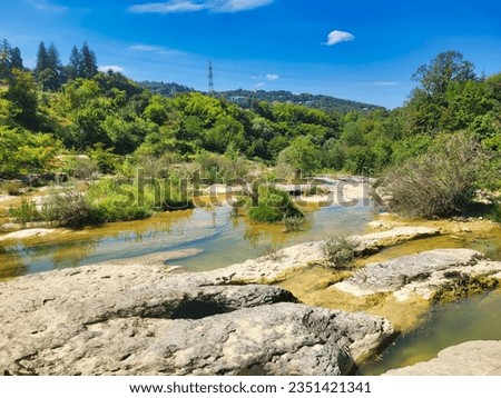 Beautiful mountain landscape, stream of mountain river, stones,. The river in a stony channel flows through a dense green forest. River landscape with natural pool. Barron gorge river