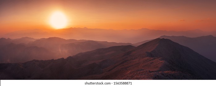 Beautiful mountain landscape with sunset over Taurus Mountains from the top of Tahtali Mountain near Kemer, Antalya, Turkey. Photo in orange and blue natural tones.