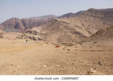 Beautiful Mountain Panorama With Lonely Farm Building Around KINGS HIGHWAY JORDAN During Access To Wadi Ghuweir Canyon In Dana Biosphere Reserve In Jordan. 