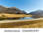 Beautiful mountain panorama at Upper Engadin Valley with Inn River in the Swiss Alps on a sunny autumn day. Photo taken November 15th, 2024, Samedan, Switzerland.