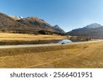 Beautiful mountain panorama at Upper Engadin Valley with Inn River in the Swiss Alps on a sunny autumn day. Photo taken November 15th, 2024, Samedan, Switzerland.