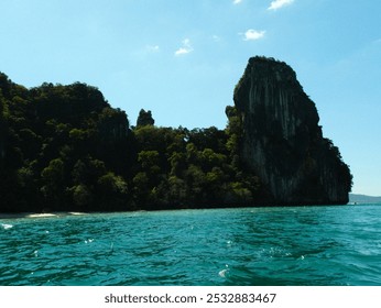 A beautiful mountain range with a body of water in front of it. The water is calm and clear, and the mountain range is covered in lush green trees. The scene is serene and peaceful - Powered by Shutterstock