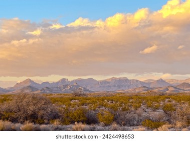 A beautiful mountain range during sunset over an empty field in Arizona.