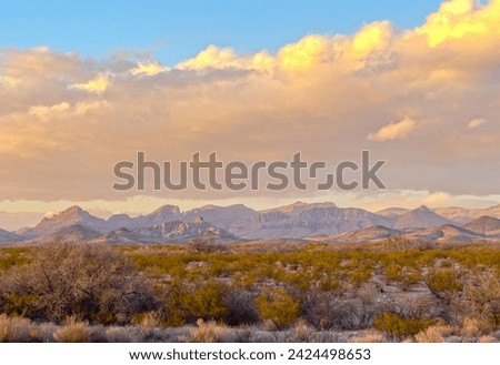 A beautiful mountain range during sunset over an empty field in Arizona.