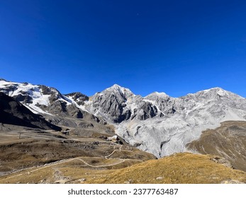 a beautiful mountain range with snow-capped peaks. a beautiful view with blue sky.