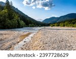 Beautiful mountain stream river bed, passing its way through the mountain terrain and forest area of slovenian Alps, under the Triglav mountain