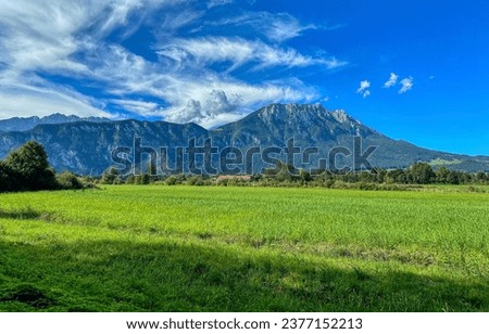 Beautiful mountain valley under a clear blue sky. Mountain valley grass. Meadow in mountain valley. Beautiful mountain landscape