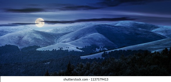 Beautiful Mountainous Background At Night In Full Moon Light. Lovely Summer Scene With Rolling Hills And Gorgeous Sky