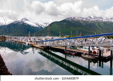 Beautiful Mountains Covered With Snow In Skagway Alaska Near The Fishing Dock With A Wooden Old Bridge