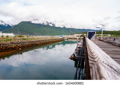 Beautiful Mountains Covered With Snow In Skagway Alaska Near The Fishing Dock With A Wooden Old Bridge