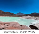 Beautiful mountains landscape with volcano and green lagoon - Piedras Rojas (Red Rocks), Atacama Desert, Chile