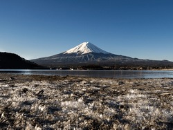 Beautiful Mt.Fuji From Kawaguchiko In The Morning In Late Winter With The Froze On The Ground As Foreground.