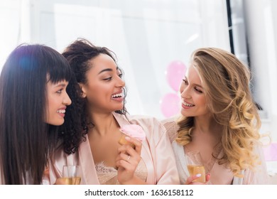 Beautiful Multicultural Girlfriends Having Fun With Champagne And Cupcake During Bachelorette Party 