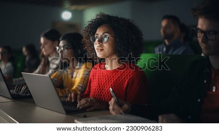 Beautiful Multiethnic African Female Student Studying in University with Diverse Classmates. Young Black Woman Using a Laptop Computer. Applying Her Knowledge to Acquire Academic Skills in Class