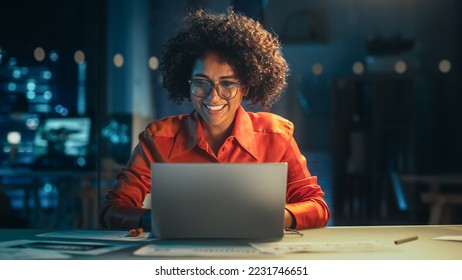 Beautiful Multiethnic Brazilian Female Working on Laptop Computer Late at Night. Young Creative Manager Having Fun in the Office, Chatting with Friends, Laughing and Feeling Happy. - Shutterstock ID 2231746651