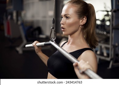 beautiful muscular fit woman exercising building muscles