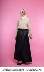 Beautiful Muslim Female Models Wearing Maxi Skirt, Bright Shirt With Hijab, Isolated Over Pink Background. Studio Fashion And Beauty Concept