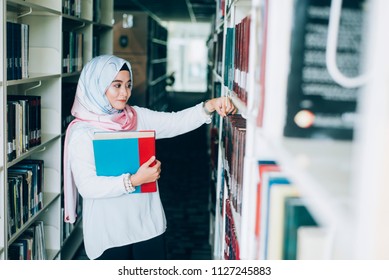 Beautiful Muslim girl reading book with hijab