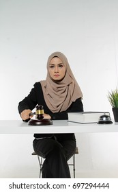 Beautiful Muslim Woman Judge Wear Hijab Striking The Gavel On A Desk. Justice And Law Concept