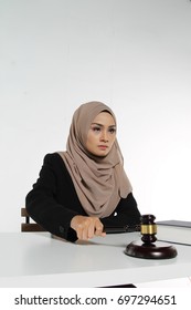 Beautiful Muslim Woman Judge Wear Hijab Striking The Gavel On A Desk. Justice And Law Concept